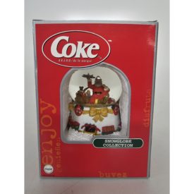 Coca-Cola Snow Globe Santa Sitting Holding Toy Airplane